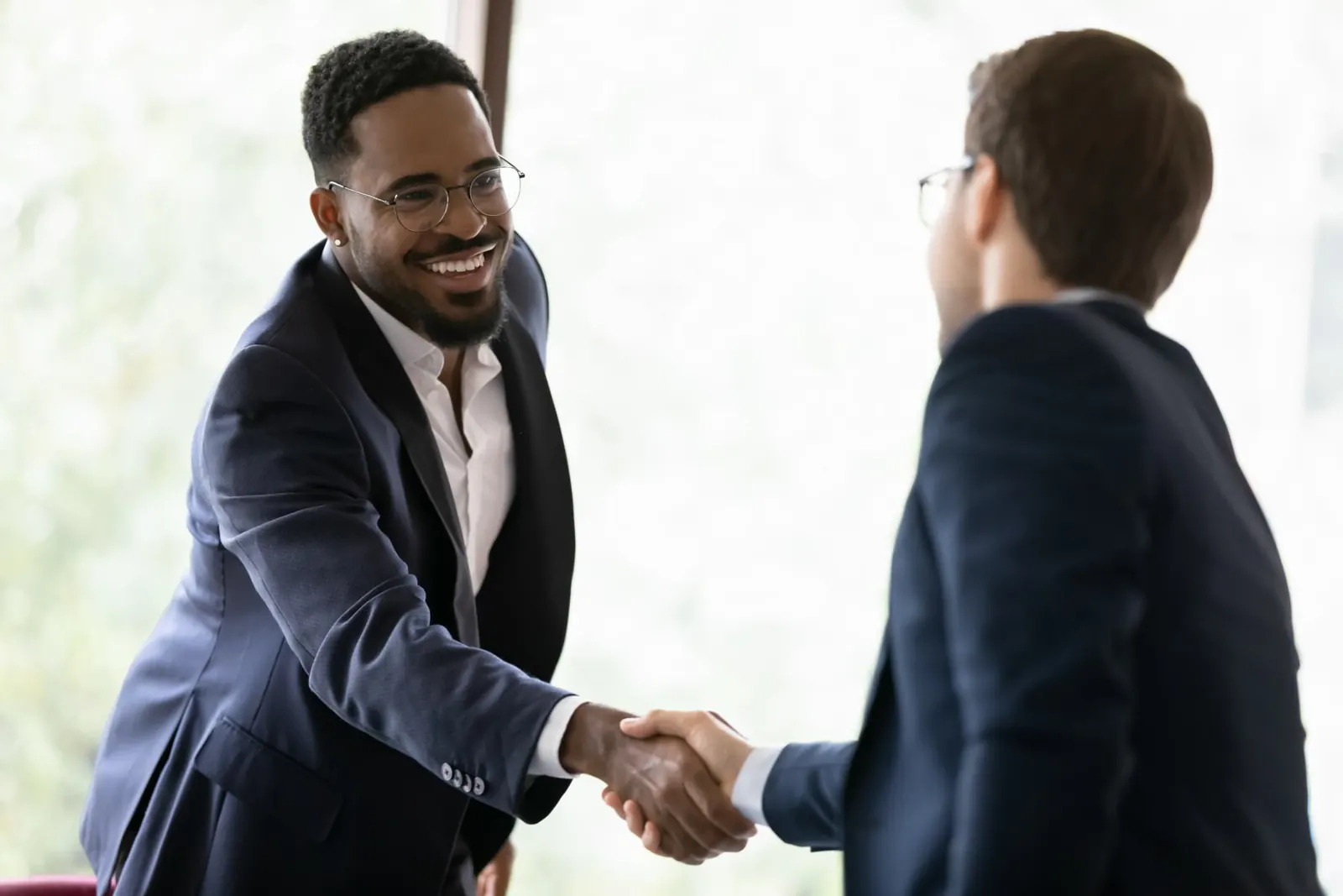 People shaking hands at a meeting